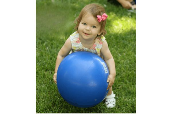 A toddler playing with a ball