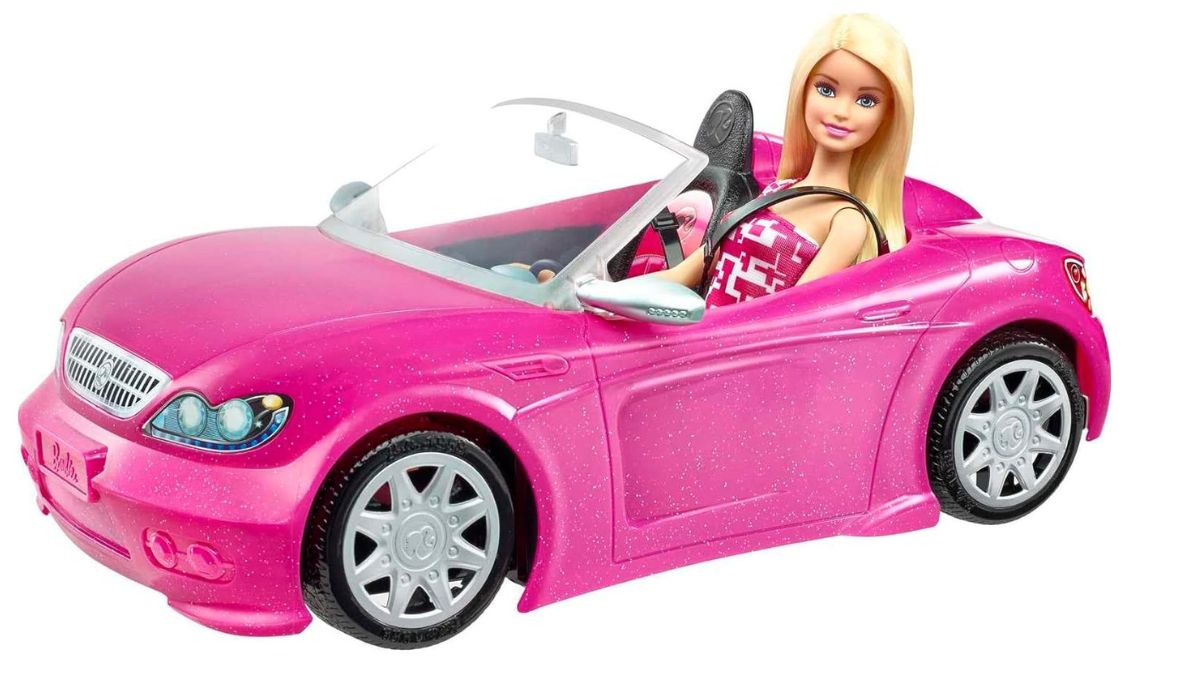 Barbie doll riding a pink car