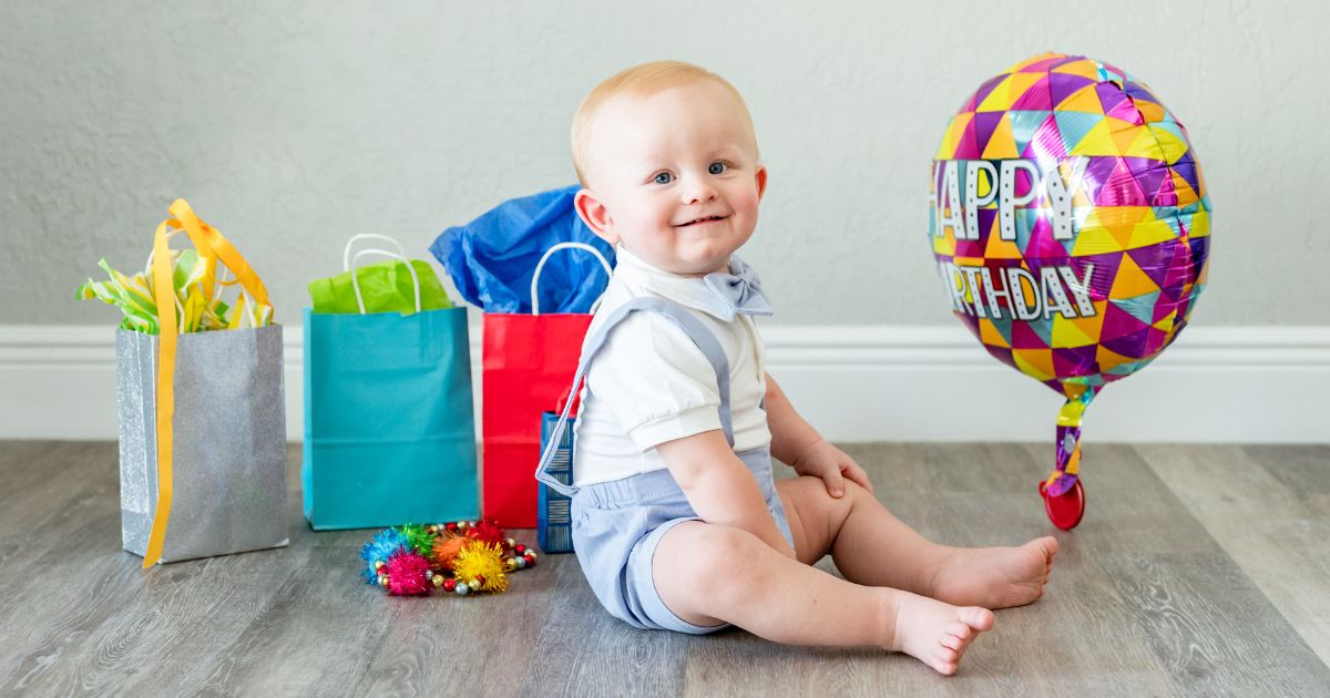 1 year old child surrounded by gifts